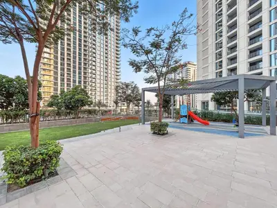 a park with a playground with a canopy and a slide at Appealing 2BR at 17 Icon Bay, Dubai Creek Harbour in Dubai