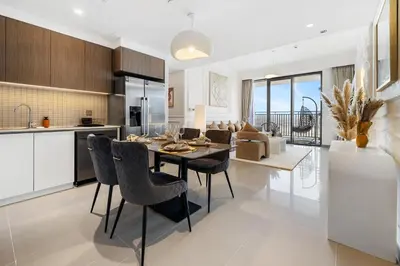 a kitchen and dining room with a table and chairs at Appealing 2BR at 17 Icon Bay, Dubai Creek Harbour in Dubai