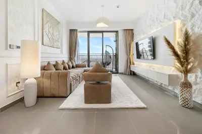 a living room with a couch and a chair at Appealing 2BR at 17 Icon Bay, Dubai Creek Harbour in Dubai
