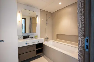 a bathroom with a tub and a sink and a mirror at Appealing 1BR at 17 Icon Bay, Dubai Creek Harbour in Dubai