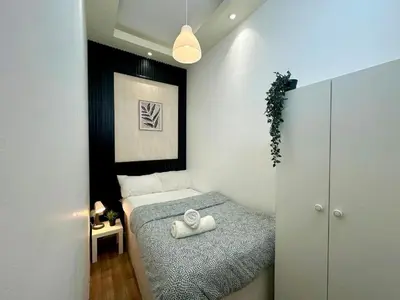 a small bedroom with a bed with towels on it at Simple Stay Partition Room In Barsha heights Tecom in Dubai