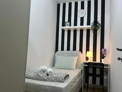 a room with a chair with towels on it at Simple Stay Partition Room In Barsha heights Tecom in Dubai