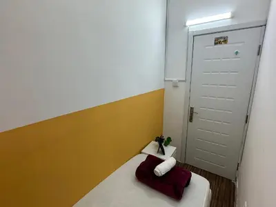 a small room with a bed and a white door at Smart Partition Room Barsha ! in Dubai