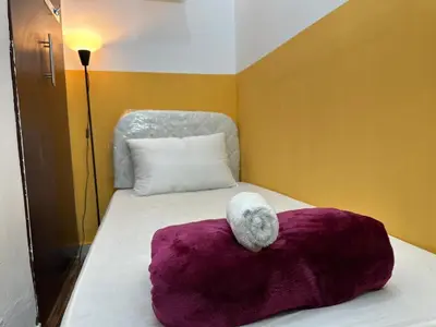 a white stuffed animal sitting on top of a bed at Smart Partition Room Barsha ! in Dubai