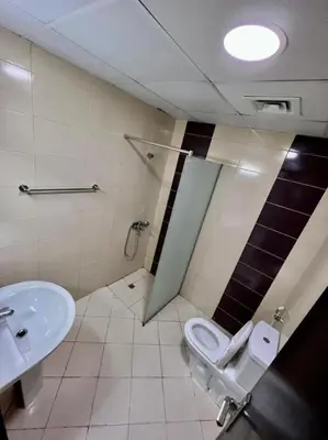 a bathroom with a toilet and a sink at Smart Partition Room Barsha ! in Dubai