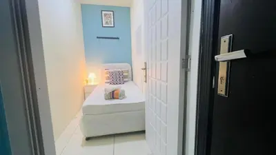 a small room with a bed in a hallway at The Pod Partition Room Al Barsha 1 in Dubai