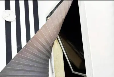 a building with a spiral staircase in front of a window at Beautiful Partition Room in Al Barsha 1 in Dubai