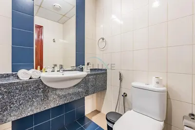 a bathroom with a toilet and a sink at Studio Near Dubai Water Canal and Bus Station, Conveniently Close to Downtown, The Scala Tower, Business Bay by Deluxe Holiday Homes in Dubai