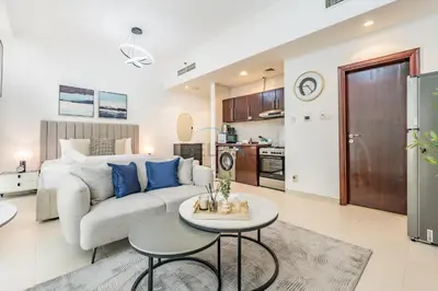 a living room with a couch and a table at Studio Near Dubai Water Canal and Bus Station, Conveniently Close to Downtown, The Scala Tower, Business Bay by Deluxe Holiday Homes in Dubai