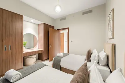 a hotel room with two beds and a mirror at FIRST CLASS 2BR Creek Beach Relax in Style in Dubai