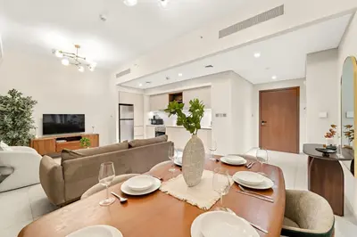 a living room with a table and a couch at FIRST CLASS 2BR Creek Beach Relax in Style in Dubai