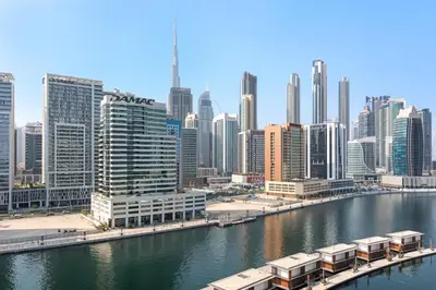 a view of a city with a river and buildings at Apartment with Burj Khalifa, Canal View with Big Balcony in Dubai