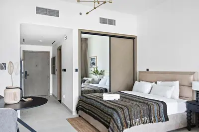 a hotel room with a large bed and a desk at Apartment with Burj Khalifa, Canal View with Big Balcony in Dubai