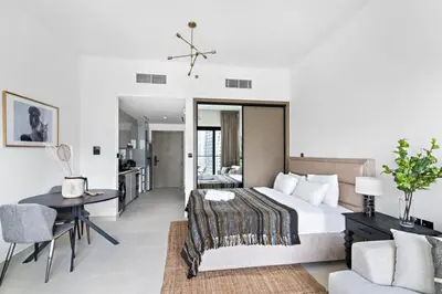 a bedroom with a bed and a table and a couch at Apartment with Burj Khalifa, Canal View with Big Balcony in Dubai