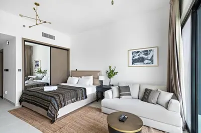 a hotel room with a bed and a couch at Apartment with Burj Khalifa, Canal View with Big Balcony in Dubai