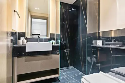 a bathroom with a sink and a glass shower at Apartment with Burj Khalifa, Canal View with Big Balcony in Dubai