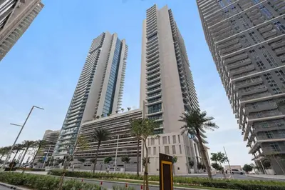 two tall buildings in a city with palm trees at FIRST CLASS 2BR Sea & Palm View, Beachfront in Dubai