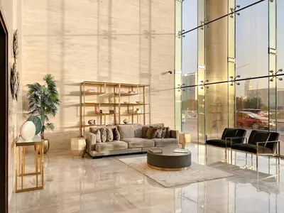 a living room with a couch and a table at Modern JVC Studio with Pool Gym and Easy Access to Attractions in Dubai