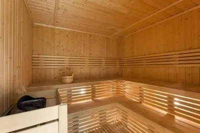 an empty wooden sauna with a plant in it at Modern JVC Studio with Pool Gym and Easy Access to Attractions in Dubai