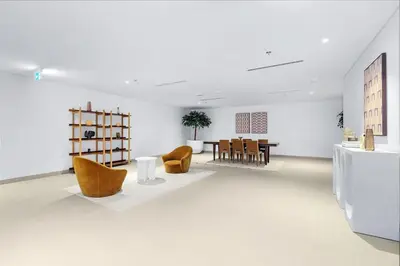 a white room with yellow chairs and a table at FIRST CLASS 4BR Luxe Downtown Escape in Dubai