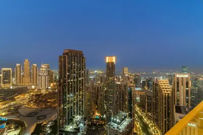 a view of a large city at night at FIRST CLASS 4BR Luxe Downtown Escape in Dubai