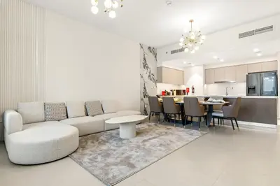 a living room with a couch and a table at FIRST CLASS 4BR Luxe Downtown Escape in Dubai