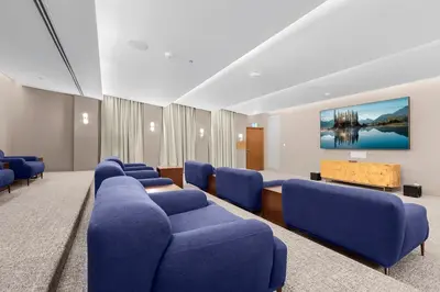 a waiting room with blue chairs and a table at FIRST CLASS 4BR Luxe Downtown Escape in Dubai