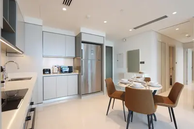 a kitchen and dining room with a table and chairs at Elegant 2BR with Dubai Marina Skyline & Sunset Views in Dubai