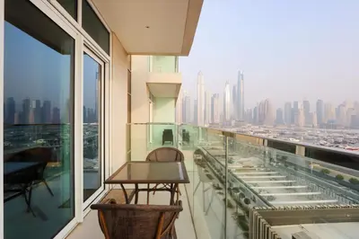 a balcony with a table and a view of the city at Elegant 2BR with Dubai Marina Skyline & Sunset Views in Dubai
