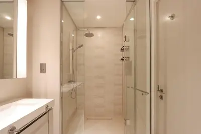 a bathroom with a shower with a glass door at Elegant 2BR with Dubai Marina Skyline & Sunset Views in Dubai