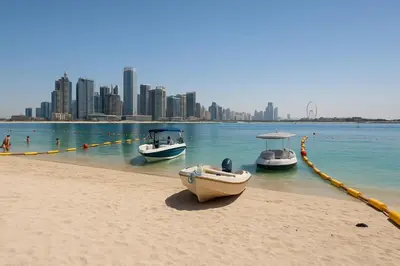 three boats on the beach with a city in the background at Happy Dom Palm in Dubai