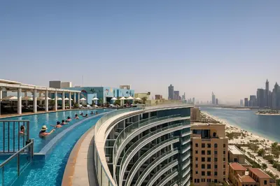 a swimming pool on the top of a building at Happy Dom Palm in Dubai