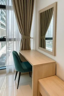 a room with a desk and a chair and a mirror at Happy Dom Palm in Dubai