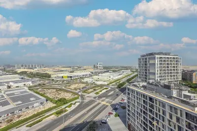 an aerial view of a city with a highway and buildings at Perfect Midtown Studio Bright & Stylish in Dubai