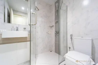 a bathroom with a shower and a toilet and a sink at Stylish 1br In Midtown Impz Soft Modern Vibes in Dubai