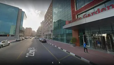 a person walking down a street in a city at Elegant Partition Room Al Barsha 1 in Dubai