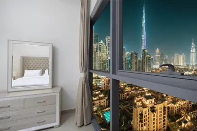 a bedroom with a view of a city at Luxury 2,5BR Burj Khalifa Views with Pool and Gym Access Near Dubai Mall in Dubai