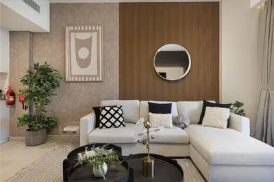 a living room with a couch and a mirror at Elegant Stay with Pool & Gym Near Iconic Landmarks in Dubai