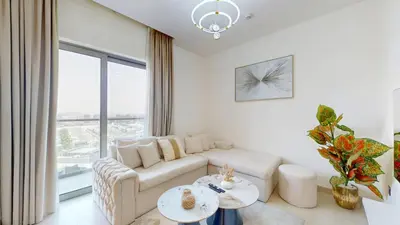 a living room with a couch and a table at Creek Vistas - Elegant One Bedroom in Meydan in Dubai