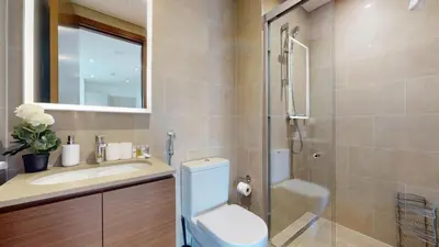a bathroom with a toilet and a sink and a shower at Creek Vistas - Elegant One Bedroom in Meydan in Dubai