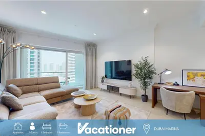 a living room with a couch and a tv at Marina Heights 1 - Opulent One Bedroom in Marina in Dubai