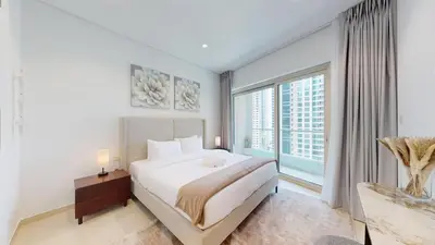 a bedroom with a large bed and a large window at Marina Heights 1 - Opulent One Bedroom in Marina in Dubai