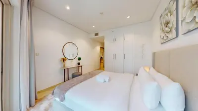 a bedroom with a white bed and a mirror at Marina Heights 1 - Opulent One Bedroom in Marina in Dubai