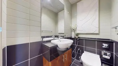 a bathroom with a sink and a toilet at Marina Heights 1 - Opulent One Bedroom in Marina in Dubai