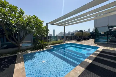 a swimming pool on the roof of a building at Modern Studio Steps from Iconic Dubai Mall & World-Class Amenities in Dubai