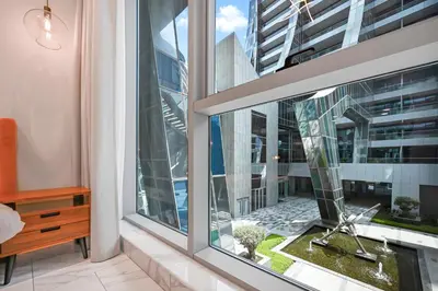 a room with a large window with a desk at Modern Studio Steps from Iconic Dubai Mall & World-Class Amenities in Dubai