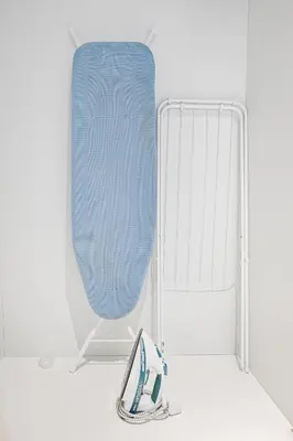 a pair of blue shoes next to a white crib at Modern Studio Steps from Iconic Dubai Mall & World-Class Amenities in Dubai