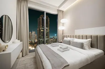a bedroom with a large window with a city skyline at Stunning 4BR with Burj Khalifa and Fountain View, Downtown Dubai in Dubai