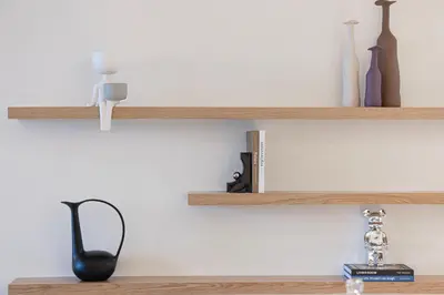 a shelf with bottles and other items on it at Stunning 4BR with Burj Khalifa and Fountain View, Downtown Dubai in Dubai