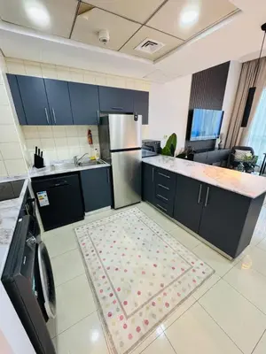 a kitchen with a refrigerator and a rug on the floor at Bay Central Sea and Canal View, Dubai Marina in Dubai